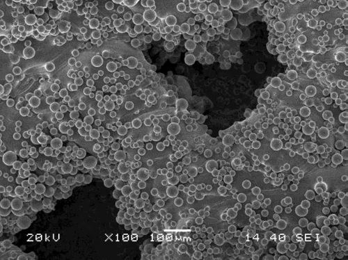 SEM image at 100x of powder globules on a part surface